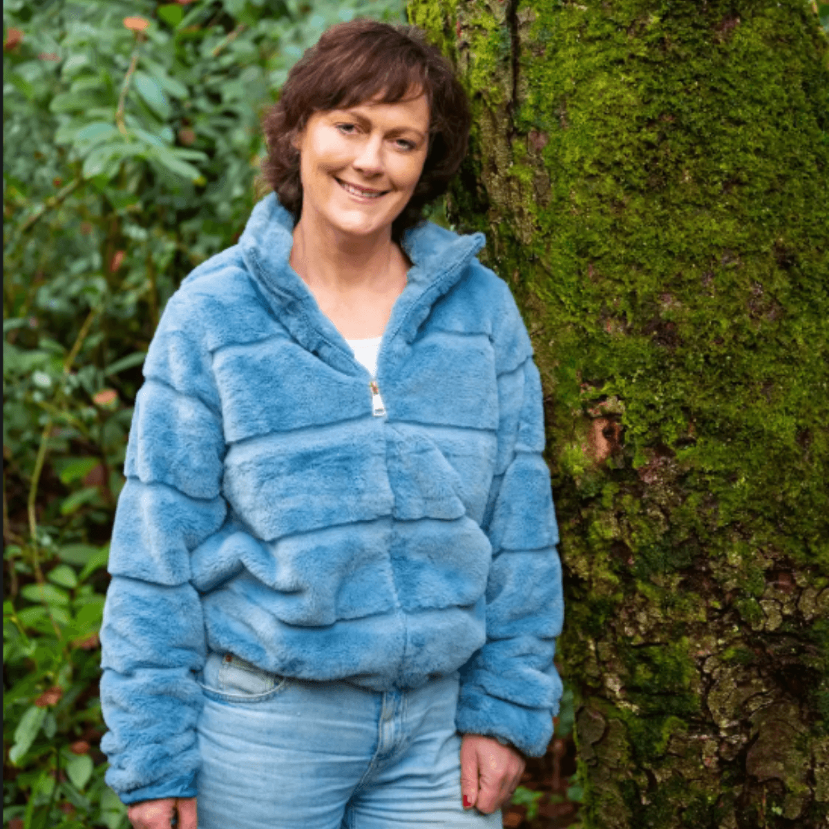 Edel Feighery Garden Designer headshot in forest